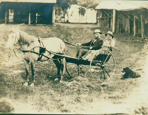 Wyman Howe and Dr. Franklin W. Brigham in the Doctor's gig in front of the Congregational horse sheds, Shrewsbury, Mass.