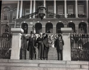 Govs. Alfred E. Smith (tipping his hat) and Joseph Buell Ely (waving to crowd) descending the steps at a reception for Smith in front of the Massachusetts State House