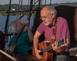 Pete Seeger (left) and Peter Yarrow playing music aboard the Mystic Whaler during the Clearwater Festival