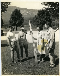 Maida L. Riggs and armed service men holding oars