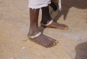 Ankle bracelets worn on a young Munda woman's feet