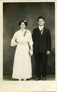 Polish American bride and bridesmaid, Weronika Skedzielewska (bridesmaid) and unidentified groomsman (l. to r.): full-length studio portrait