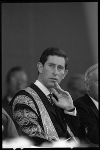 Prince Charles in academic robes, seated, at the 350th anniversary celebration of Harvard University