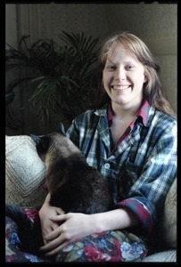 Amy Carter: half-length portrait, seated with Siamese cat in her Brown University apartment
