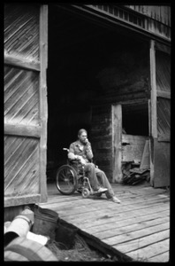 Peter Natti in his wheelchair, parked in the entrance to the barn, Montague Farm commune