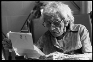 Victoria Moore, 103 years old, reading a letter