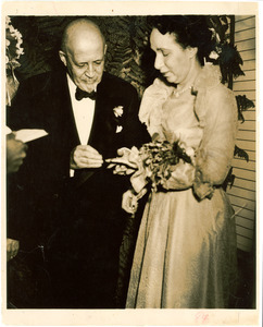 W. E. B. Du Bois placing ring on finger of Shirley Graham Du Bois during wedding ceremony