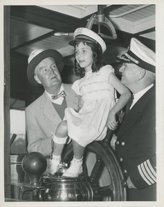President Bruce Barton and ship captain show little girl how to steer