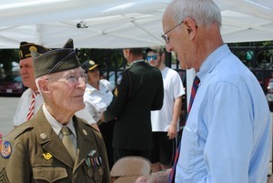 Congressman John W. Olver: portrait, talking with an veteran of the 8th Air Force, World War II