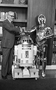 Unidentified man with R2-D2 and C-3P0 from Star Wars film at Boston City Hall