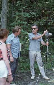 Unidentified woman, Richard Babcock, and Hank Flynt (left to right) at Moon Barn Raising at entrance to Hopkins Forest on 2 August 1975.