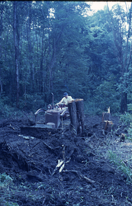 New Moon Barn site preparation at HMF entrance. Howard Oakes driving small bulldozer.