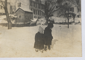 Two children playing in snow