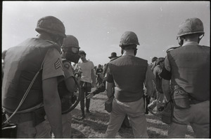 Antiwar demonstration at Fort Dix, N.J.: military police with gas masks facing protesters