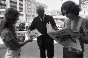 Boston Phoenix promotional photos: Phoenix hawker handing paper to man, Stephen Davis (r) reading