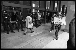 Antiwar protesters picketing the entrance to the John F. Kennedy Federal Building as police stand by