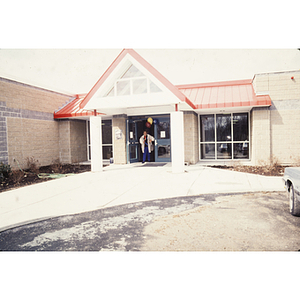 Man with balloons exiting YMCA branch building