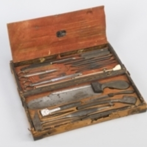 Autopsy set containing saws, chisels, knives, directors, forceps, and gastrointestinal scissors