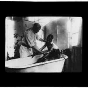 Patient being helped in a bath