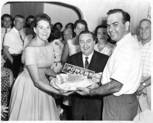 John Joseph Moakley and Evelyn Moakley presenting John E. Powers with cake, 1955