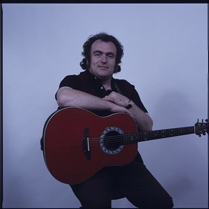 John Watt, "Ireland's singing farmer." Studio portraits posing with guitar. Also sitting on fishing boat in Ardglass, Co. Down