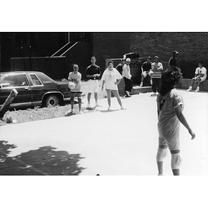 Woman preparing to serve the ball during a volleyball game.