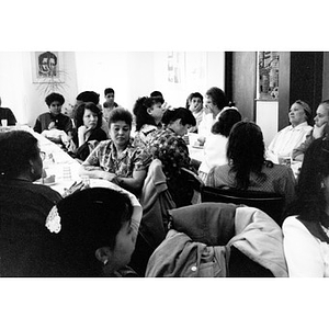Community members gathered around long tables for a meeting in the Inquilinos Boricuas en Acción offices.
