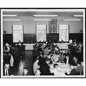 Boys' Club officers and guests seated around tables in an auditorium at a Boys' Clubs of Boston awards event