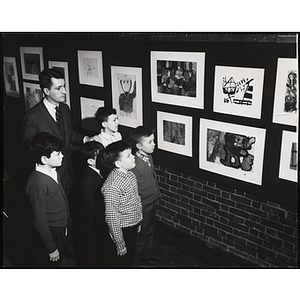 William O. Taylor II, Overseer of the Boys' Clubs of Boston, viewing the Boys' Clubs of Boston Art Exhibit with five Club members: Blaine Campbell, Michael Powell, Joe Perry, Eugene DeCosta, and Via Walker