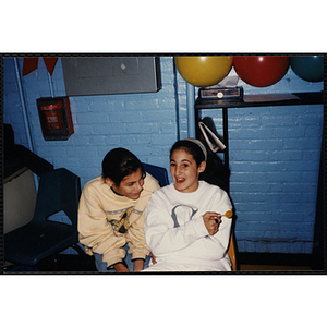 Two girls laughing and smiling at an open house