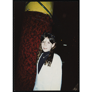 A girl stands next to a column at Chez Vous Roller Rink at the Tri-Club roller skating party