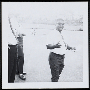 A man gesturing while two others look on during a Boys' Club Little Sister Contest