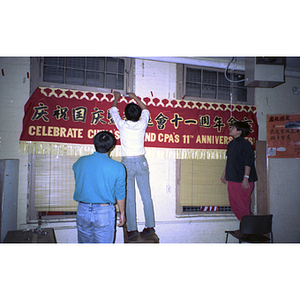 Members decorate for a Chinese Progressive Association anniversary event