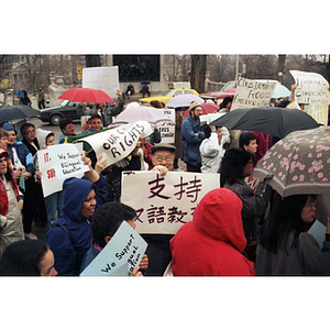 Chinese man holds a sign in Chinese as he participates in a bilingual education rally at the Massachusetts State House