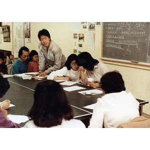 Students sit around a table at a job training class