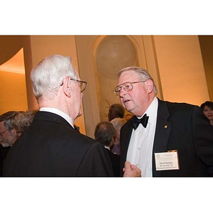 Neal Finnegan converses with a man at the inauguration celebration of President Aoun