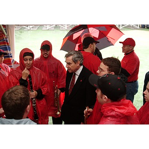 President Freeland talks with members of the NU marching band at the Homecoming game