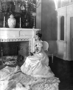 Portrait of Miss Lule Palfrey, seated on a chair in the ballroom, facing left, Arthur Little House, 2 Raleigh Street, Boston, Mass., undated