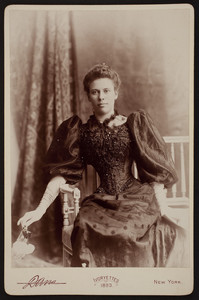 Three-quarter portrait of Jane Armstrong Tucker, seated, facing front, holding flowers,1893