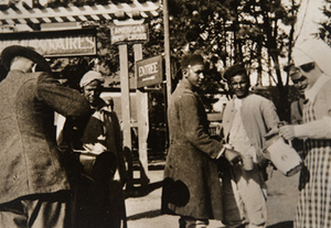 Red Cross workers offering beverages to soldiers outside a canteen
