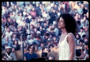 Jefferson Airplane performing at Woodstock: Grace Slick on stage, with audience in background