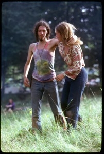 Couple walking through the field, arms around each other, at the Woodstock Festival