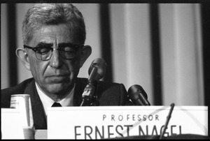 Ernest Nagel. moderator of the second panel, speaking at the National Teach-in on the Vietnam War: seated behind his name tag