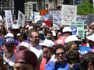 Crowd of antiwar marchers in the streets of New York, with signs and banners opposing the war in Iraq