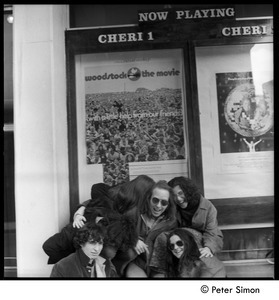 Stephen Davis (left) and friends huddled beneath a poster for the Woodstock movie, Cheri I theater