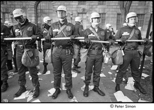 Members of the Civil Disturbance Unit lined up with batons