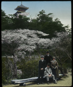 Japan (westerners in front of flowering tree, shrine in background)