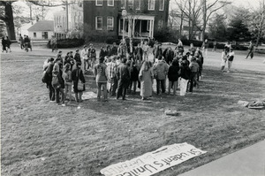 Rally near Whitmore Hall, UMass Amherst, with banners reading 'CIA out of UMass' and 'Students united will never be defeated'