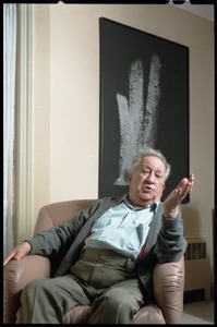 Fine art photographer Aaron Siskind: seated in a armchair in his living room