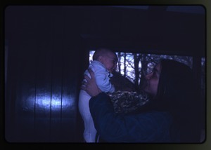 Unidentified woman holding baby (Eben), Montague Farm Commune